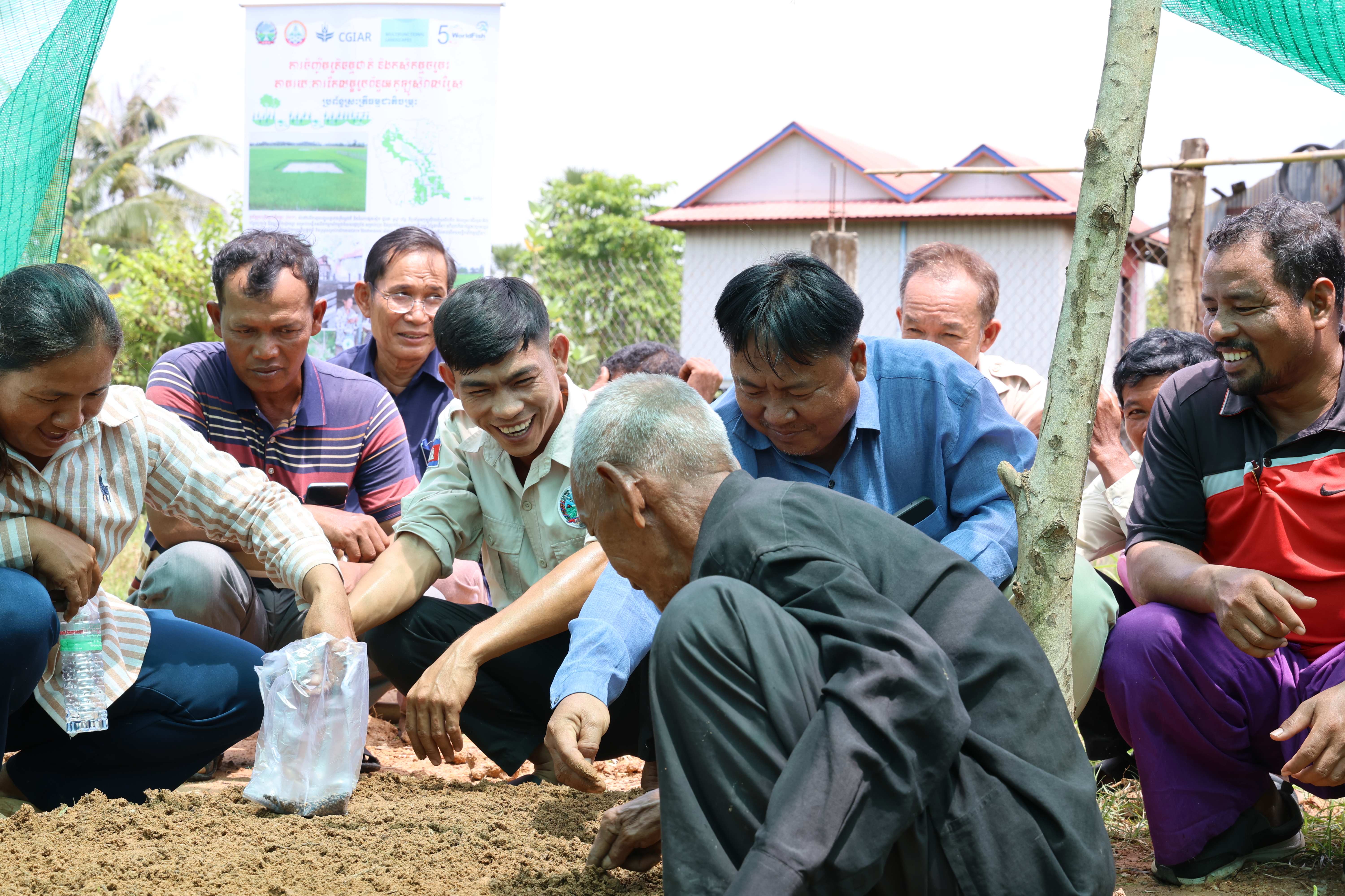On-the-job training on seeding in integrated ricefield ponds, conducted by the Commune Agriculture Officer, Cambodia 
