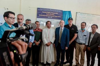 VIPs in front of plaque)