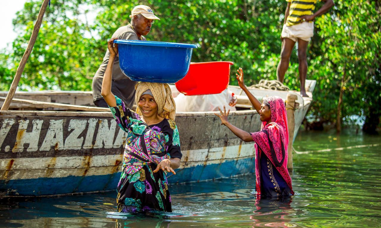This group of photos captures the fish processing journey from the moment the fish is landed from the sea to its final distribution. The images highlight key stages, including offloading from fishing vessels, boiling to preserve quality, sun-drying for longer storage, and packaging before being transported to markets. Photo by Festo Lumwe