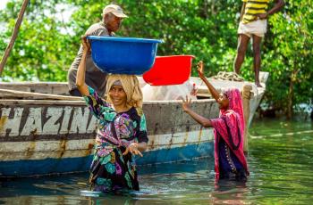 This group of photos captures the fish processing journey from the moment the fish is landed from the sea to its final distribution. The images highlight key stages, including offloading from fishing vessels, boiling to preserve quality, sun-drying for longer storage, and packaging before being transported to markets. Photo by Festo Lumwe