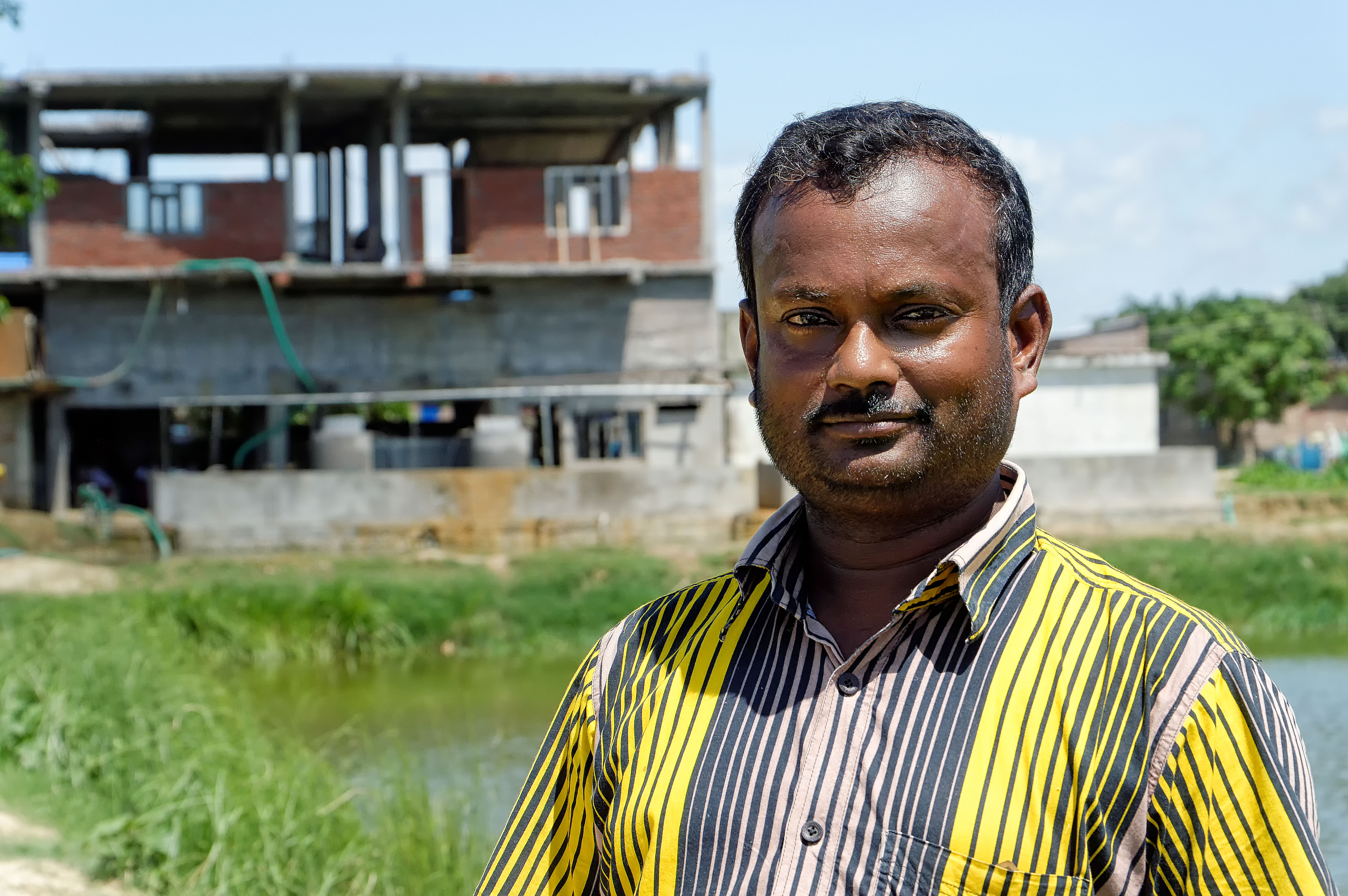Ambarish Patel Patanawar in front of his hatchery in 2014 (under construction). Photo: Ahmed Nur Orko/CGIAR-AAS/WorldFish Bangladesh