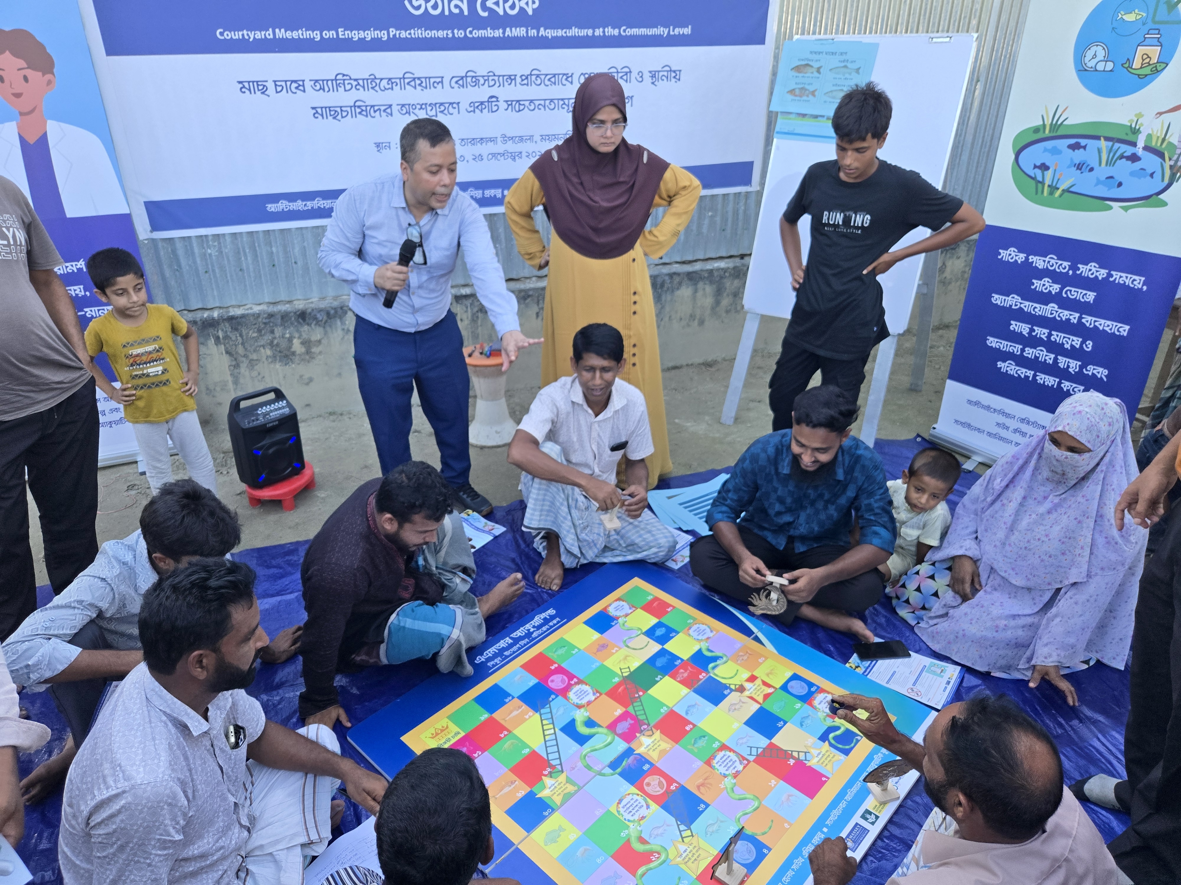 Farmers playing the AQUASHIELD Snake and Ladder game in the Practitioner Engagement Program (PEP) conducted in Dhaka, Bangladesh. Photo: Abdullah-Al-Mahmud/WorldFish