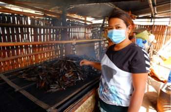 Win Chewa Htun produces smoked fish for a living together with her husband. Photo by Kyaw Moe Oo.